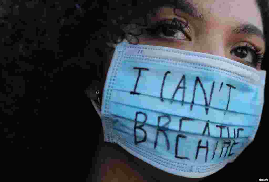 A woman wearing a face mask with the words "I can't breathe" looks on during a protest in front of a U.S. consulate in Barcelona, Spain, June 1, 2020, against the death in Minneapolis police custody of George Floyd.