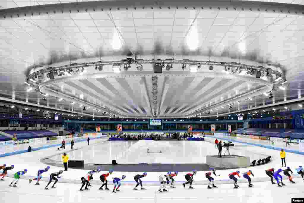 Participants compete in the men's mass start skating event during the ISU European Speed Skating Championships at the Thialf ice arena in Heerenveen, Netherlands, Jan. 9, 2022.