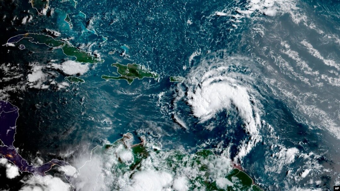 This satellite image provided by the National Oceanic and Atmospheric Administration shows a tropical storm east of Puerto Rico in the Caribbean, at 7:50 a.m. EST, Aug. 10, 2021.