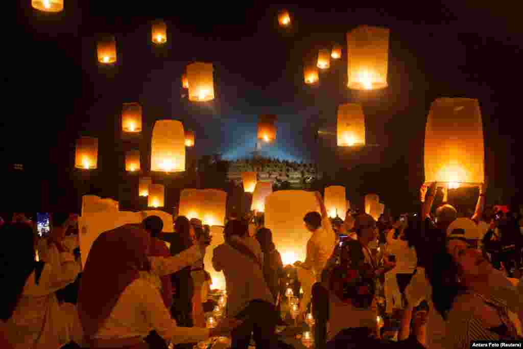 Visitors release paper lanterns to celebrate Vesak Day at the Borobudur temple in Magelang, Central Java province, Indonesia.