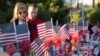 FILE - A couple looks over 58 wooden crosses, with the names and photos of the October 1 mass shooting victims, in the median of Las Vegas Boulevard South near the "Welcome to Las Vegas" sign in Las Vegas, Nevada, Oct. 9, 2017.