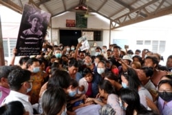 People mourn as they attend the funeral of Kyaw Win Maung, who was shot and killed during a protest against the military coup, in Mandalay, Myanmar, March 28, 2021.