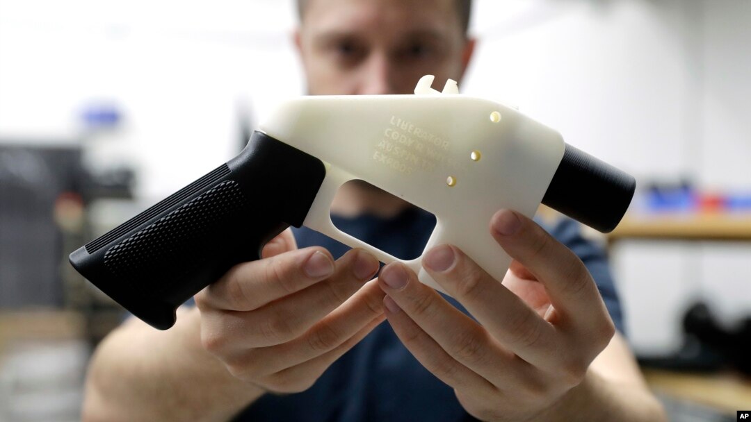 Cody Wilson, with Defense Distributed, holds a 3D-printed gun called the Liberator at his shop in Austin, Texas, Aug. 1, 2018.