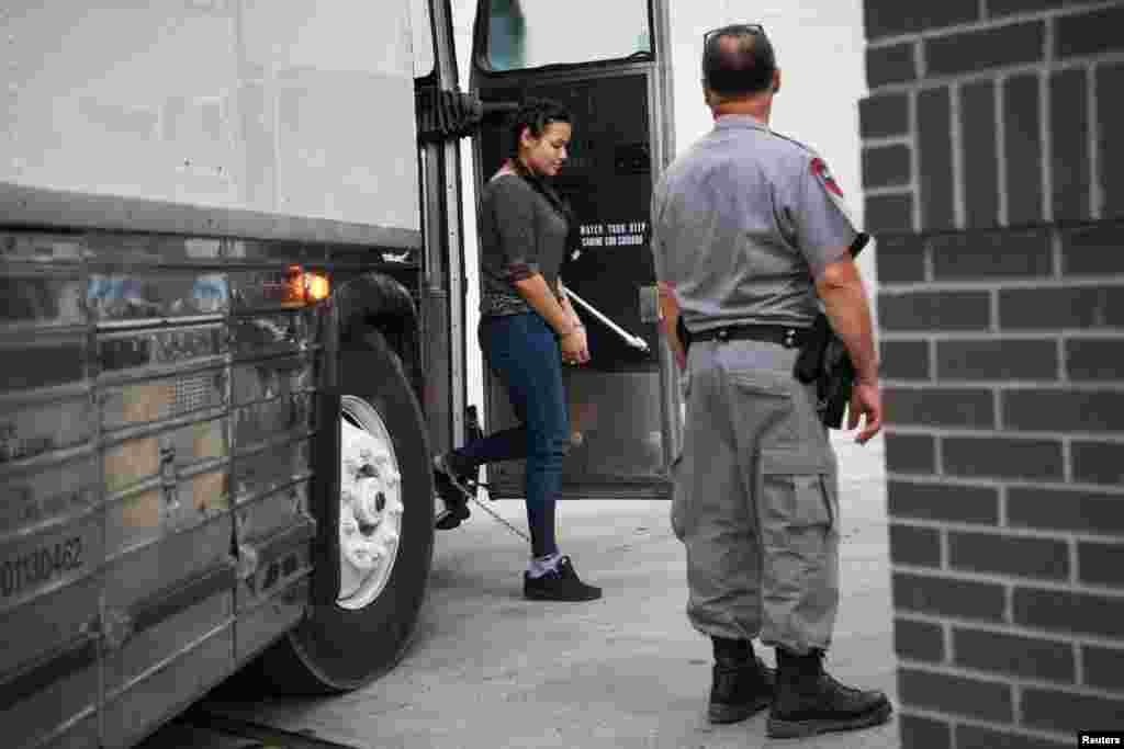 A shackled migrant woman in federal custody arrives for an immigration hearing at the U.S. federal courthouse in McAllen, Texas.