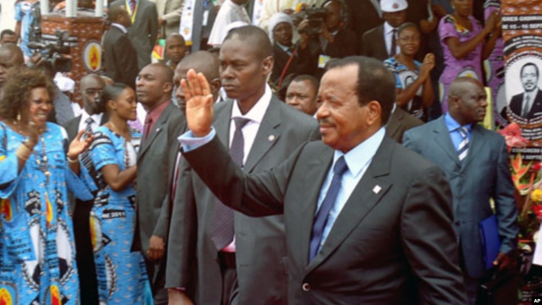 Cameroon's President Paul Biya waves to supporters during the opening of his party conference, in Yaounde, on September 15, 2011.