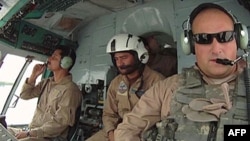 FILE - U.S. Air Force Major Micah West helps to train Afghan pilots in the southern province of Kandahar in August 2010. 