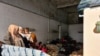Refugees take shelter in a gas station in Turkey saying they want to cross the closed Greek border and do not want to be taken to Istanbul, were they could be homeless and potentially exposed to coronavirus on March 18, 2020. (Heather Murdock/VOA)