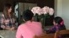 Felicia Luna, more relaxed after viewing her aneurysm through virtual reality, talks to her children on the day before her brain surgery. 