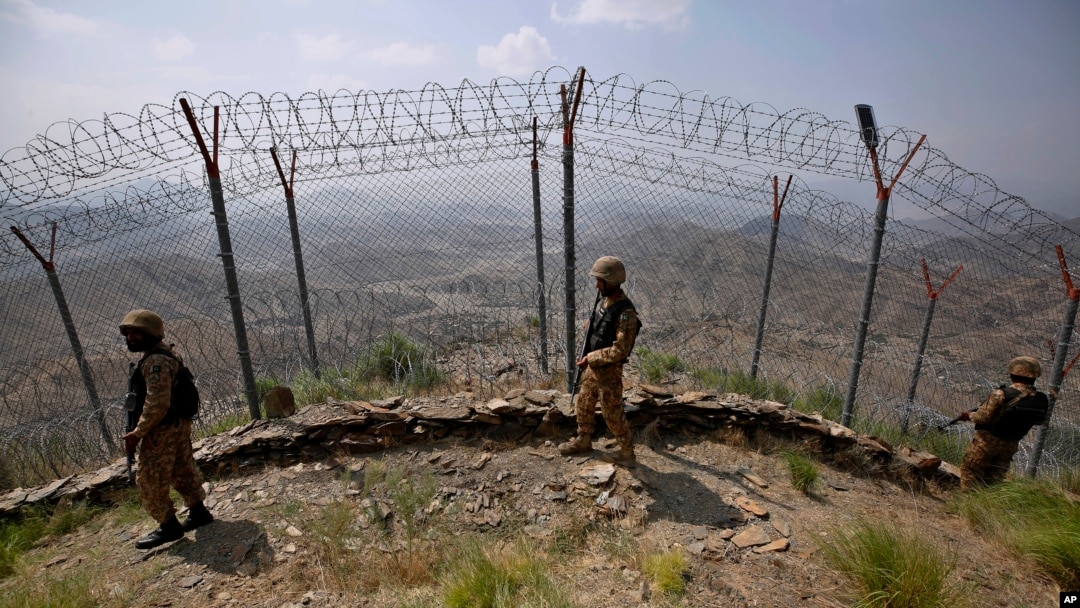 FILE - Pakistan Army troops patrol along the fence on the Pakistan-Afghanistan border at Big Ben hilltop post in Khyber district, Pakistan, Aug. 3, 2021.
