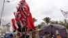 Iraqi flags resembling a tree adorn Tahrir Square, in Baghdad, which has been occupied by protesters for months, on Jan. 21, 2020. (Heather Murdock/VOA)