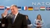U.S. Secretary of State Mike Pompeo, left, waits for the start of the North Atlantic Council at NATO headquarters in Brussels, April 27, 2018. 