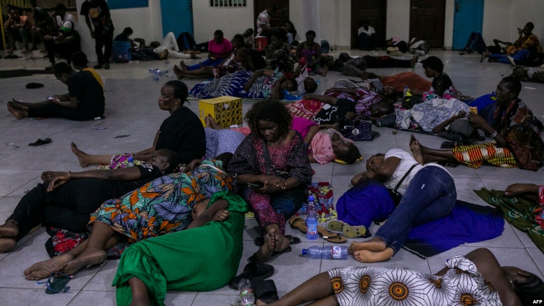 Voters gather and rest on the floor at the end of the voting day in a polling station at the Reverend Kim School in Kinshasa, Congo, on Dec. 20, 2023.