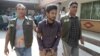 Police officers in Dhaka detain Nahid Hasan, a member of Jamaat-e-Islami, Bangladesh's biggest religion-based party, on suspicion he was involved in Islamic State propaganda, Nov. 25, 2015.