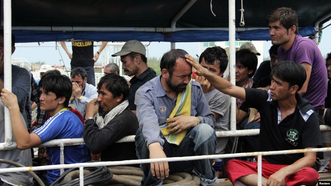 Asylum seekers from Afghanistan, Iraq and Iran cry as Indonesian officers force them to leave the Australian vessel Hermia docked at Indah Kiat port in Merak, Indonesia's Banten province, April 9, 2012. 