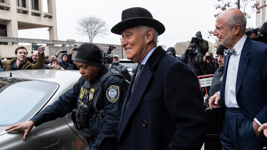 FILE - Roger Stone, center, departs federal court in Washington, Feb. 20, 2020. 