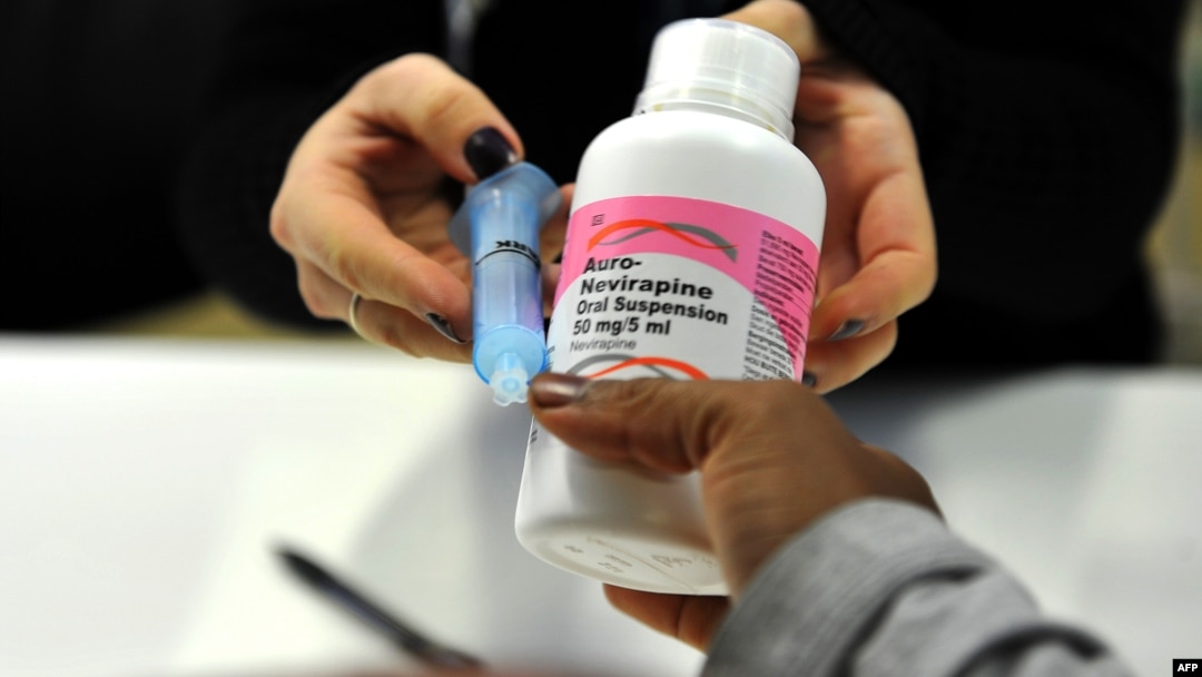 FILE - A mother gets antiretroviral drugs at the Chris Hani Baragwanath Hospital in Soweto, South Africa on May 16, 2012.