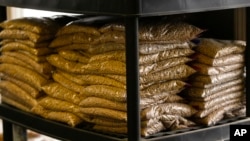 FILE - Bags of sample yellow soybeans are stored at Deerfield Farms Service on April 5, 2018, at the facility in Volant, Pa. After the Trump administration unveiled plans to impose tariffs on $50 billion in Chinese imports, China lashed back, matching the American tariffs with plans to tax $50 billion of U.S. products, including soybeans, corn and wheat. Tariff talk has ratched upward since then.