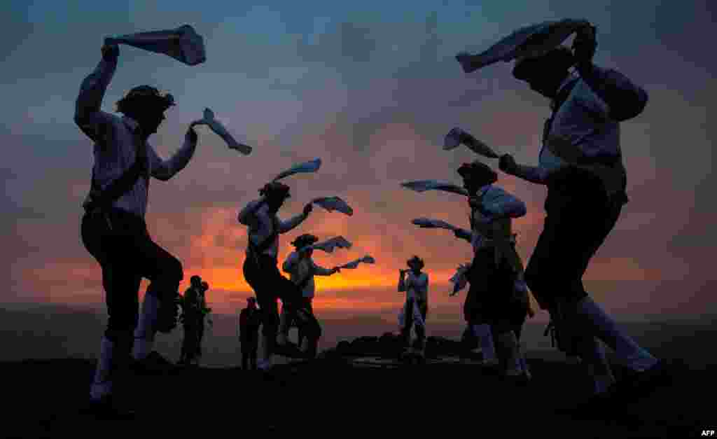 The Chapel-en-le-Frith dancers perform an annual dance atop the Eccles Pike in Derbyshire, Britain, at sunrise, as part of the ancient Celtic festival Beltane, celebrated on May Day or the beginning of summer.