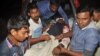 A man injured in an attack on a Shi'ite mosque is carried for treatment in Bogra district, Bangladesh, Nov. 26, 2015.