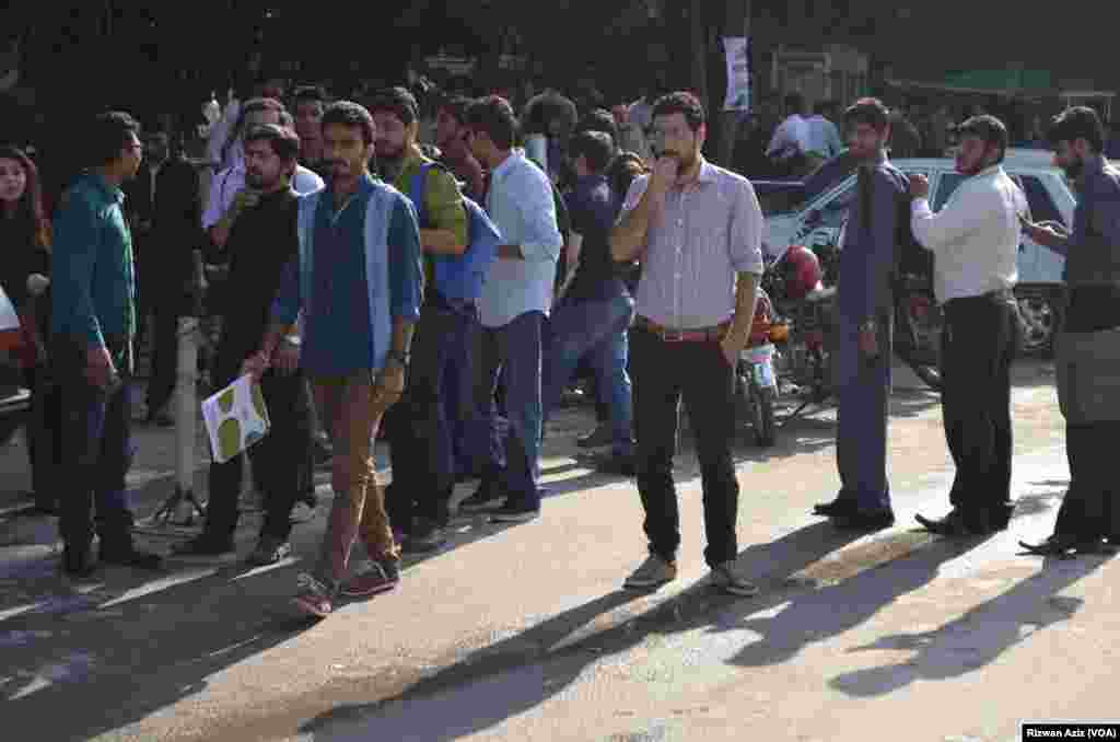 People gather outside after a strong earthquake shook northern Afghanistan and Pakistan. 