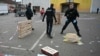 French municipal police officers collect evidence at the site of a bladed weapon attack where a man is suspected of killing one person and wounding two municipal police officers in Mulhouse, eastern France, Feb. 22, 2025. 