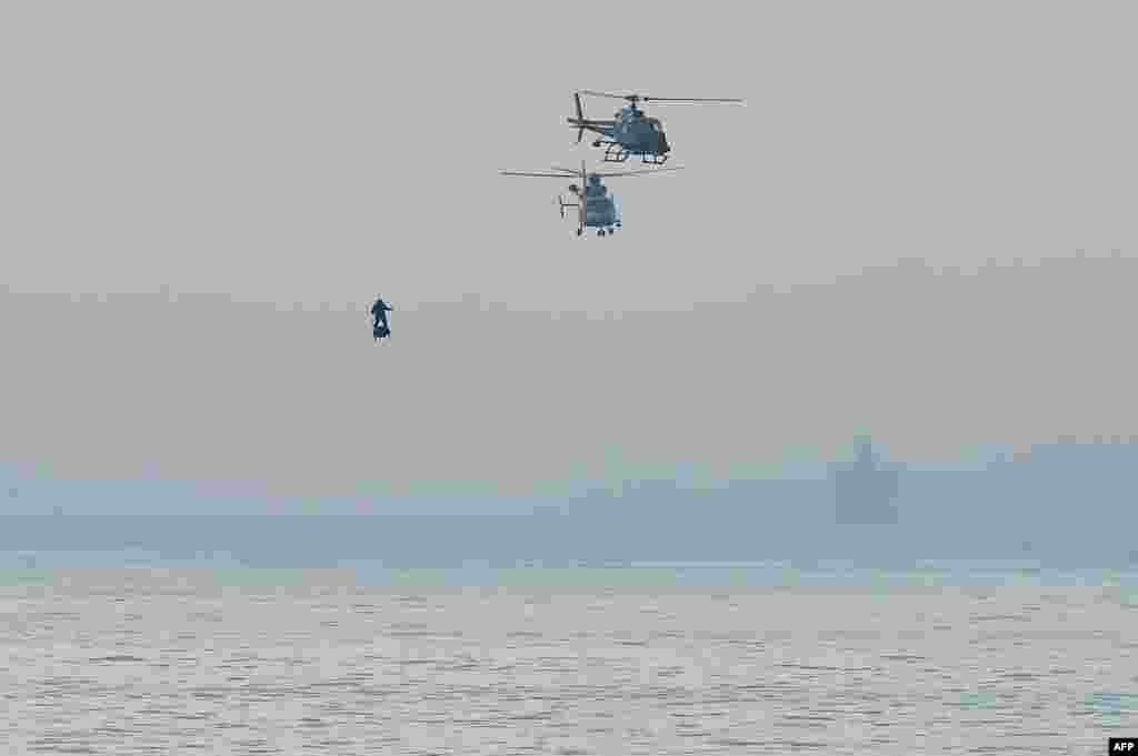 Franky Zapata on his jet-powered "flyboard" arrives at St. Margaret's Bay in Dover, England, during his attempt to fly across the 35-kilometer (22-mile) English Channel crossing in 20 minutes, with an average speed of 140 kilometers an hour (87 mph) at a height of 15-20 meters (50-65 feet) above the sea.
