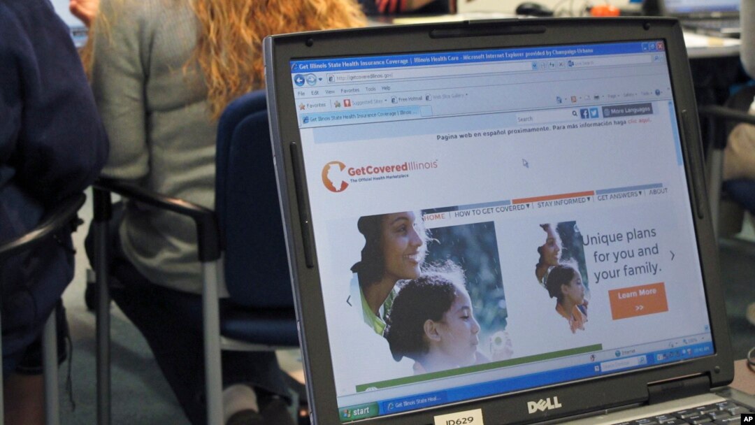 Staff members from the Champaign Urbana Public Health District offices in Champaign, Ill., work with people trying to sign up for health care coverage through the Affordable Care Act, Oct. 1, 2013. 