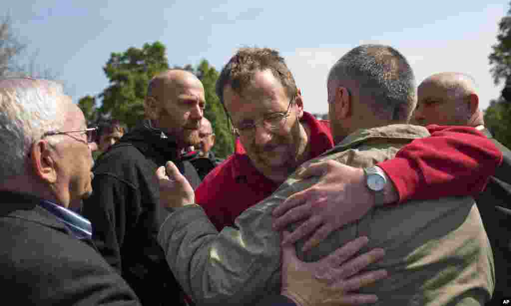 Russia's presidential human rights ombudsman Vladimir Lukin watches as foreign military observers hug each other following their release in Slovyansk, eastern Ukraine, May 3, 2014.