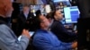 People work on the floor at the New York Stock Exchange in New York, March 4, 2025.