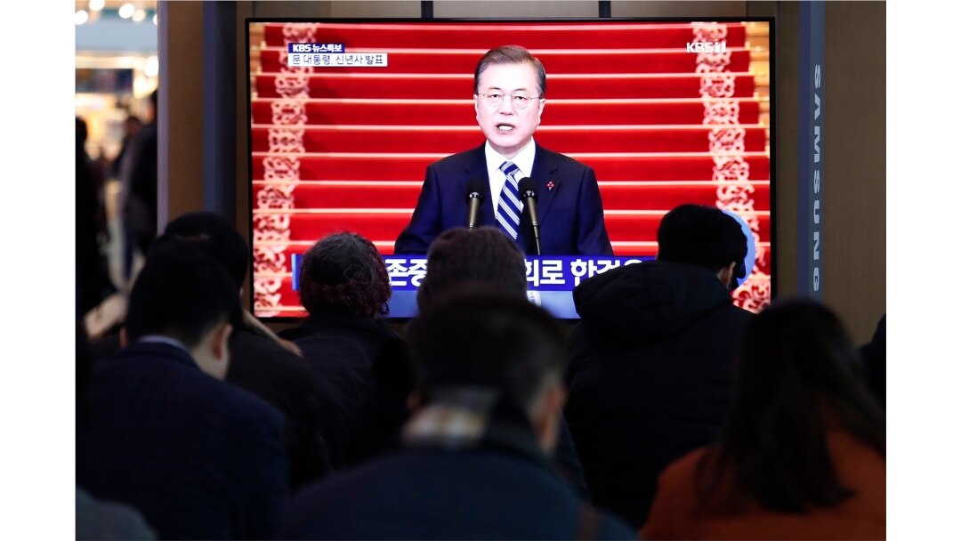 People watch a TV screen showing the live broadcast of South Korean President Moon Jae-in's New Year's speech at the Seoul Railway Station in Seoul, Jan. 7, 2020.