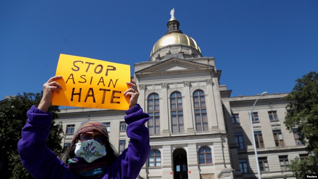 A person holds a placard during a "Stop Asian Hate" rally, following deadly shootings in the area, in Atlanta, March 20, 2021. 