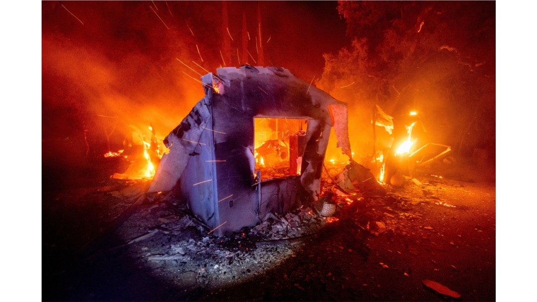Flames from the LNU Lightning Complex fires consume a home in unincorporated Napa County, Calif., Aug. 19, 2020.