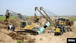 Iranian construction crews work on a water distribution project called Ghadir in the southwestern province of Khuzestan, July 2, 2018. The project is aimed at resolving clean-water shortages that triggered several days of mass streets protests in the region beginning June 29. 