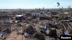 Pessoas no meio de edifícios destruídos, árvores arrancadas e escombros depois da passagem do ciclone Chido, de Mecufi, Moçambique, 16 dezembro 2024 (Unicef ​​​​Moçambique/Divulgação via Reuters)