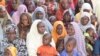 Women wait for free baby food donations from the U.N.'s World Food Program in Maiduguri, Nigeria, Oct. 2016. (C. Oduah/VOA)