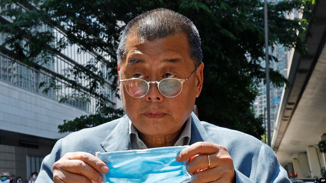 FILE - Hong Kong media tycoon Jimmy Lai enters a court in Hong Kong on May 5, 2020. A key prosecution witness in Lai's trial on collusion and sedition charges may have been mistreated in custody, U.N. officials say, drawing into question whether his testimony was coerced.
