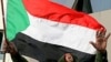 Sudanese President Omar al-Bashir waves to the crowd gathering outside the Defense Ministry in the capital Khartoum to celebrate retaking the oil town of Heglig from South Sudanese forces, April 20, 2012. 