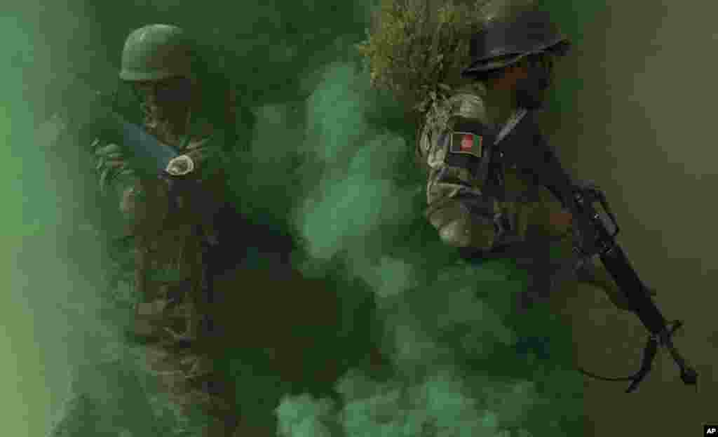 Afghan National Amy commandos take their positions near a building during a military exercise in Kabul.