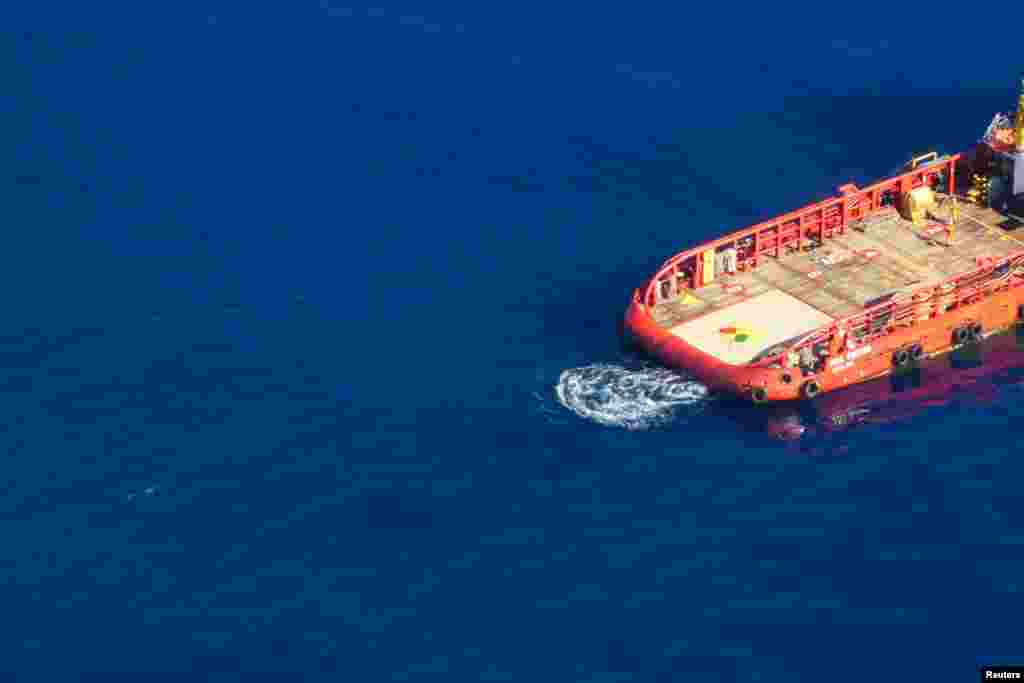 Aerial view shows a migrant swimming towards Gibraltar-registered Vos Triton commercial offshore supply ship, in Search and Rescue (SAR) zone off Libya's coast as seen from Germany's Sea-Watch humanitarian organisation's Moonbird aircraft.